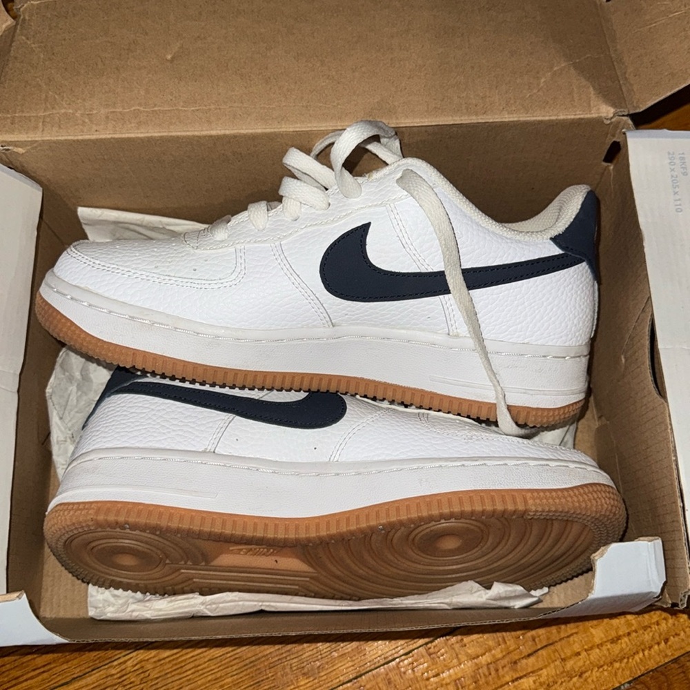 Navy blue Nike Air Force 1 with bubble gum sole.